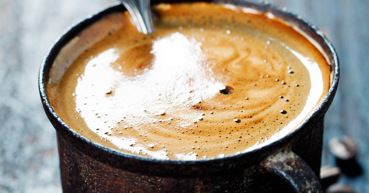 maca coffee being stirred in a mug