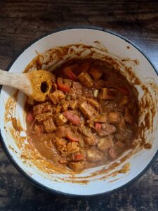 Peanut butter tempeh curry cooking in a pot